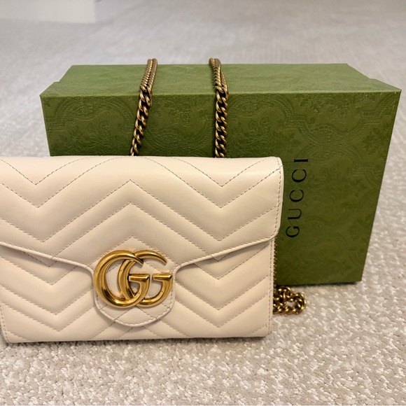 Gucci Handbags - Gucci Cream Clutch with Gold Accents